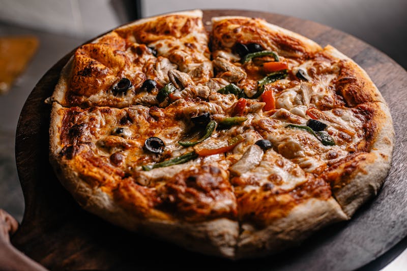 Pizza Ranch team crafting ranch pizza with fresh ingredients